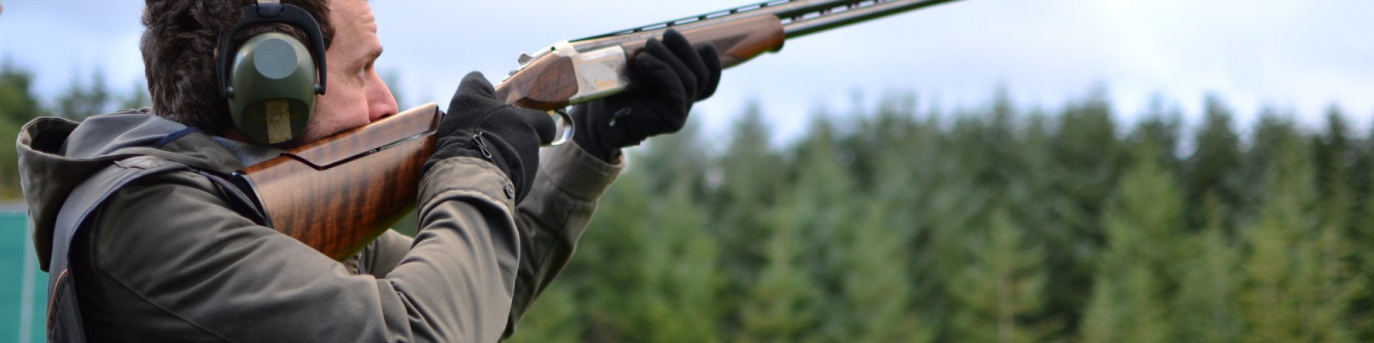 Canva man shooting shotguns at clay pigeon outdoors