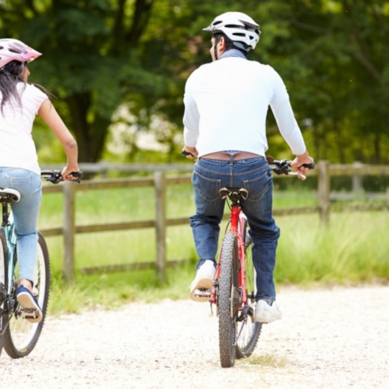 A couple cycling in the Scottish countryside