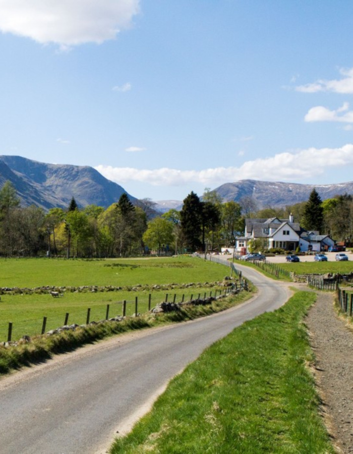 Glen Clova Hotel in distance with path running alongside