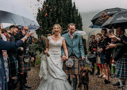 A Bride and Groom and their Dog with confetti being thrown over them. Photography by Burfly. https://burfly.co.uk/