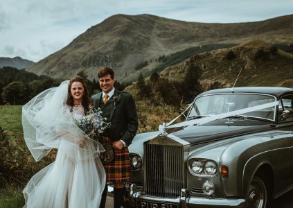 A bride and groom next to their wedding car in Glen Clova. Photography by Danny Birrell Photography. https://www.dannybirrellphotography.co.uk/