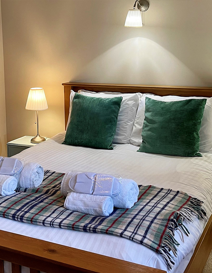 A cosy bedroom in Brandy Cottage at Glen Clova Hotel and Lodges