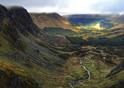 Corrie Fee in Glen Clova with its stunning mountainous landscape on moody Scottish day.