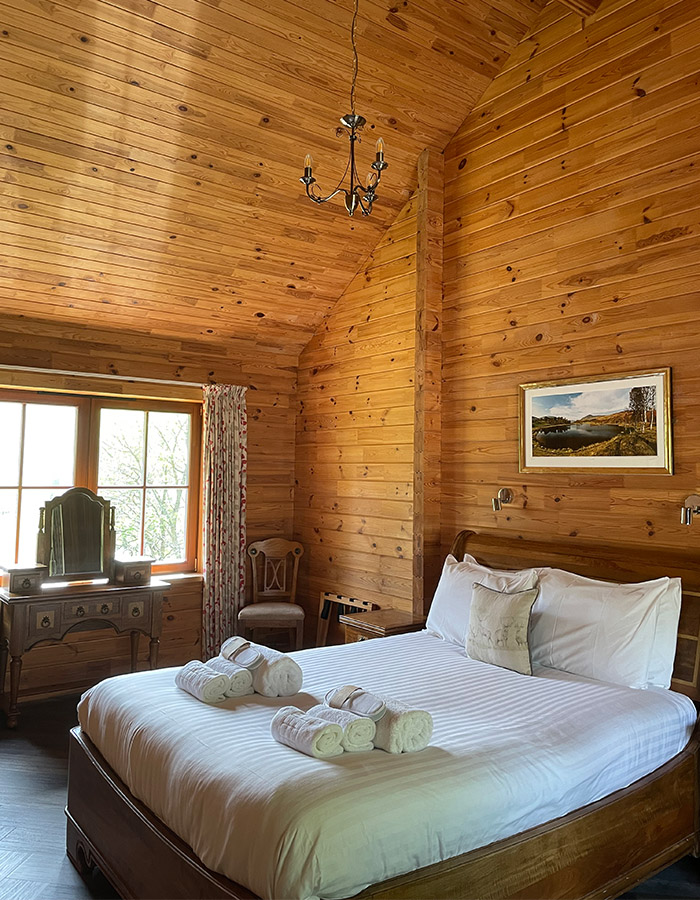 A cosy double bedroom in a Hideaway Lodge at Glen Clova Hotel and Lodges in Scotland