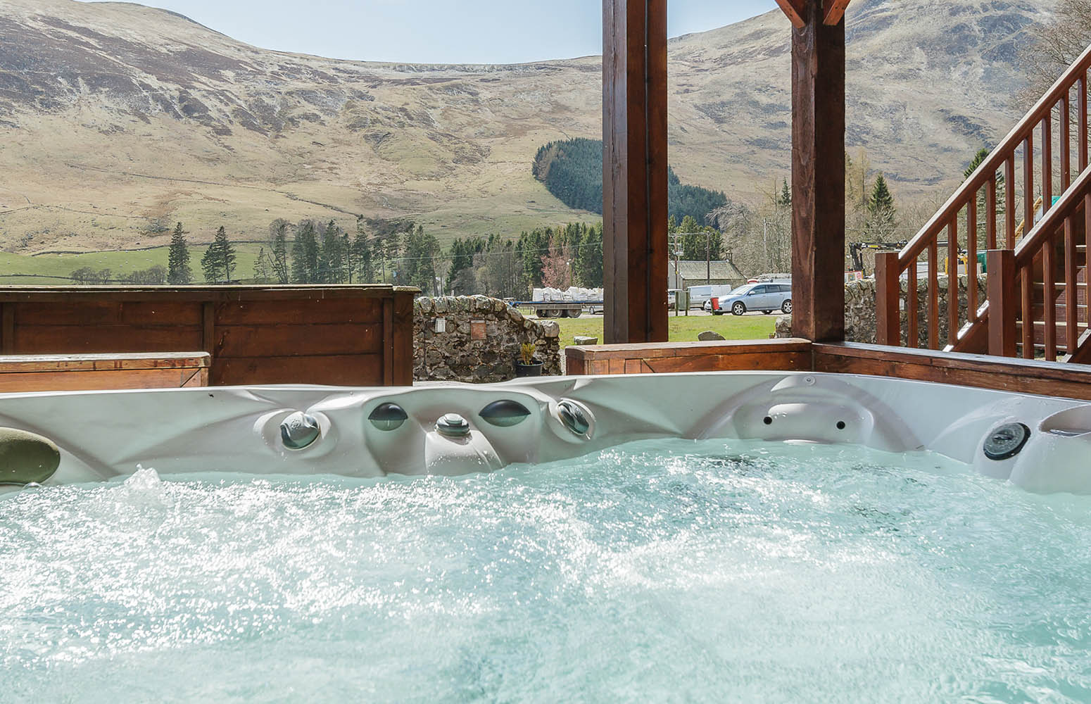 A hot tub with a stunning view on a Glen Lodge at Glen Clova Hotel and Lodges in Scotland
