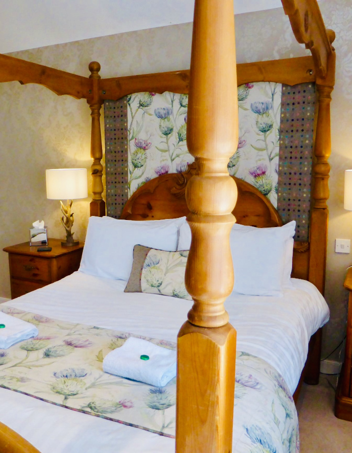 Four poster bed in traditional hotel room