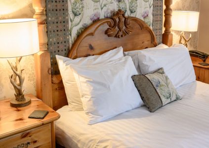 Close up of bed in four poster room