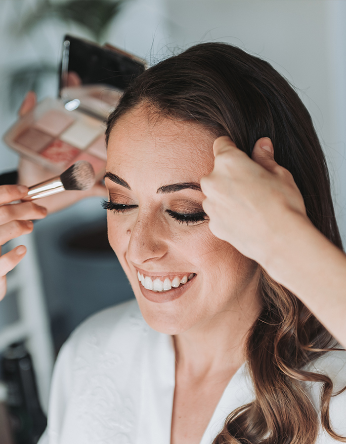 A bride having her hair and makeup done