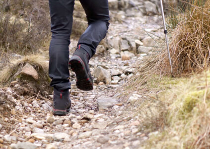 A walker's legs on a rocky path in Scotland