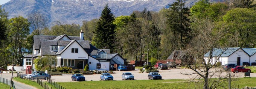 The road leading up to Glen Clova Hotel with the Cairngorm hills in the background