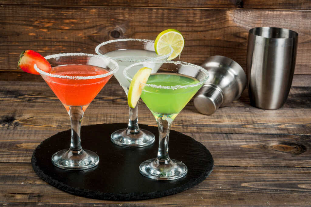 Three colourful cocktails on a tray 